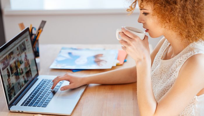 woman-photographer-drinking-coffee-and-working-PJNBP6U@2x.jpg